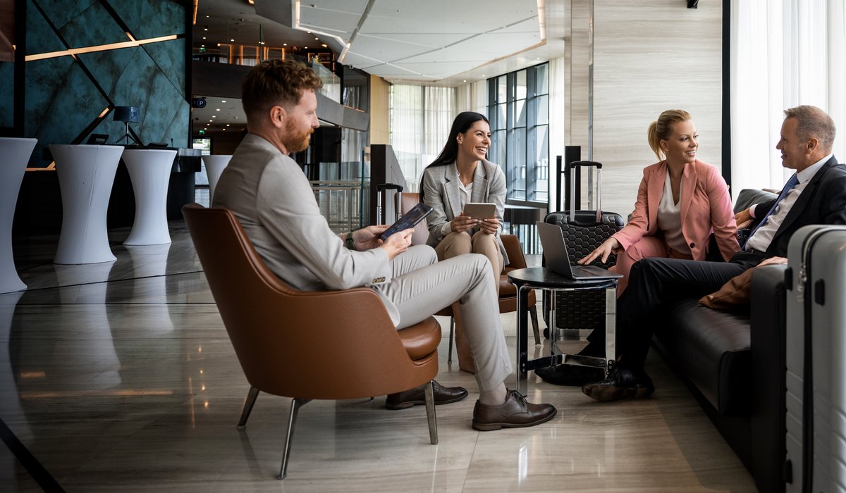 HEC Group hospitality team discussing connected guestroom, automation, and building performance solutions